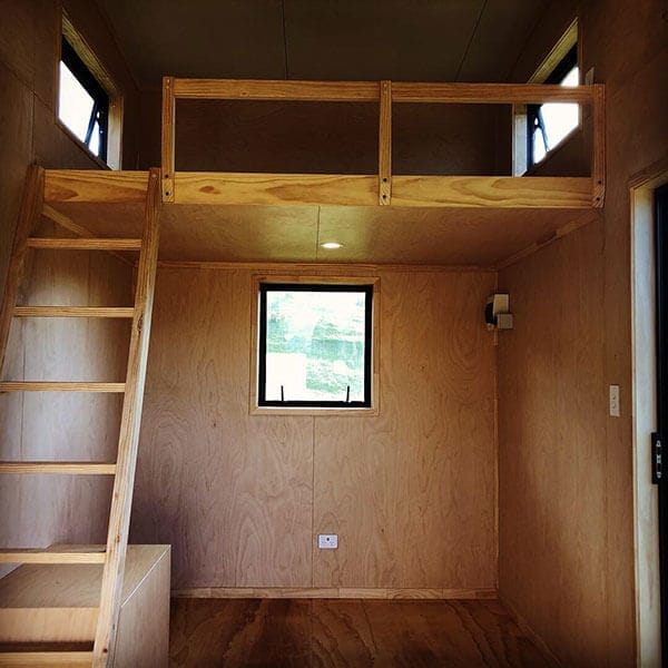 ply lined cabin showing stairs ladder and mezzanine level