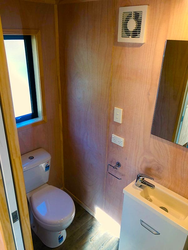 Bathroom in Tiny Home showing toilet and vanity sink