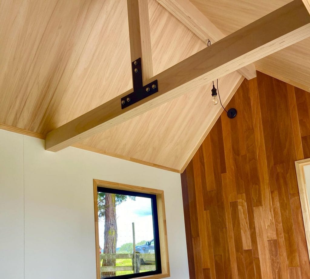 Everest Tiny Home by Fox Cabins showing exposed beams and feature wall