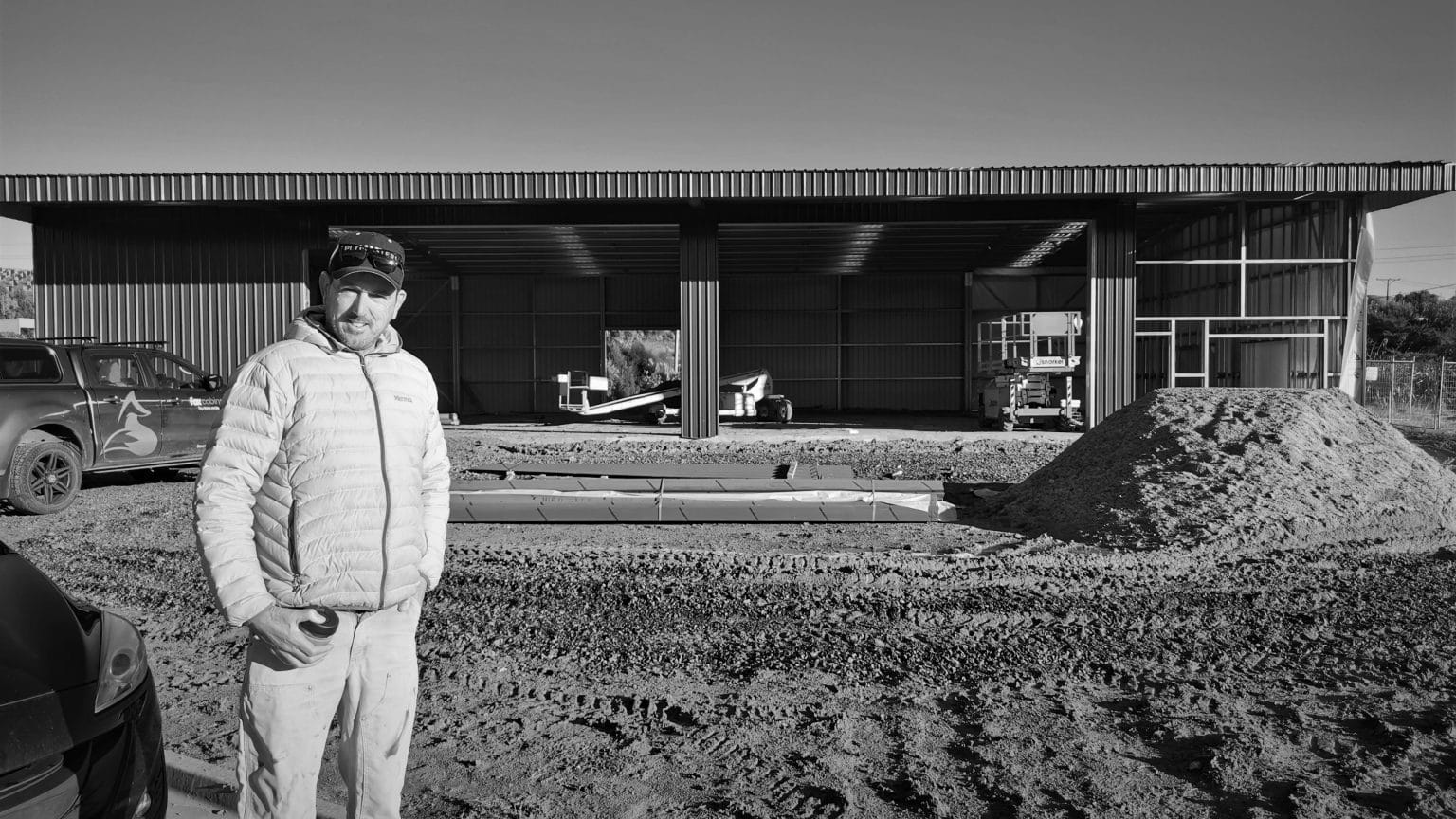 Adam Fox standing outside the the new Tiny Home workshop in Raglan while it was under construction. 2021