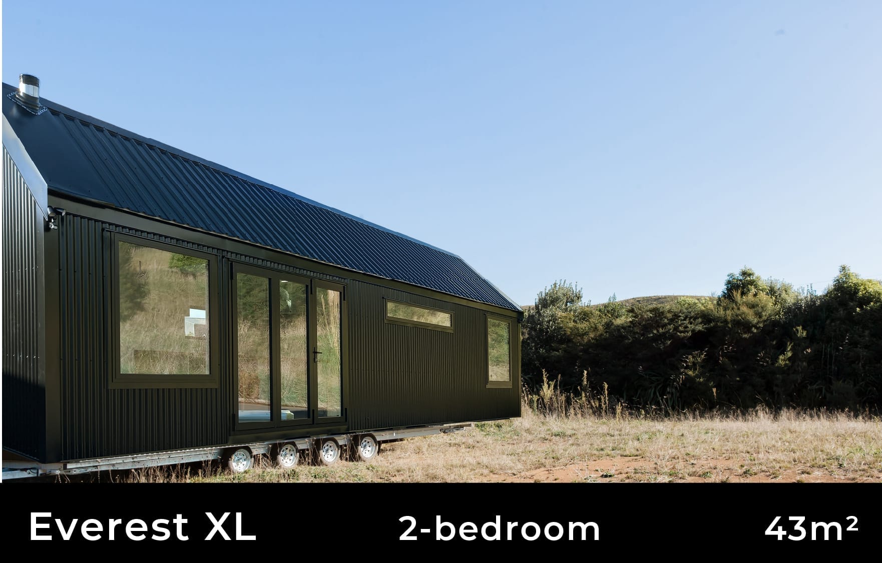 Everest XL 3 Bedroom Tiny Home by Fox Cabins with deck built onsite by client.